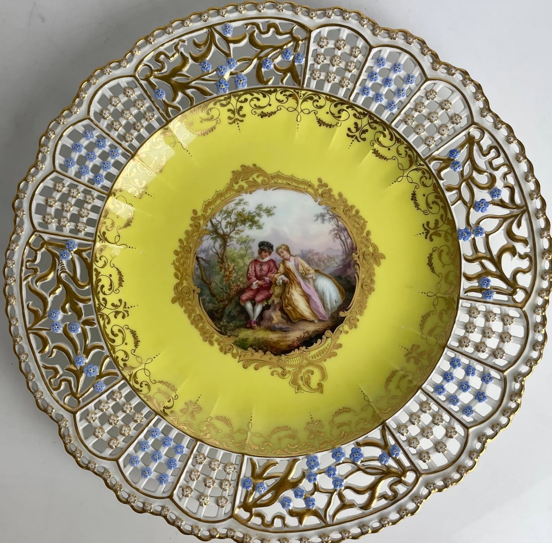 19TH C. MEISSEN YELLOW GROUND RETICULATED PLATE: Painted with Watteau scene . Measures 11” d. In mint condition. Estimate $2500-3000