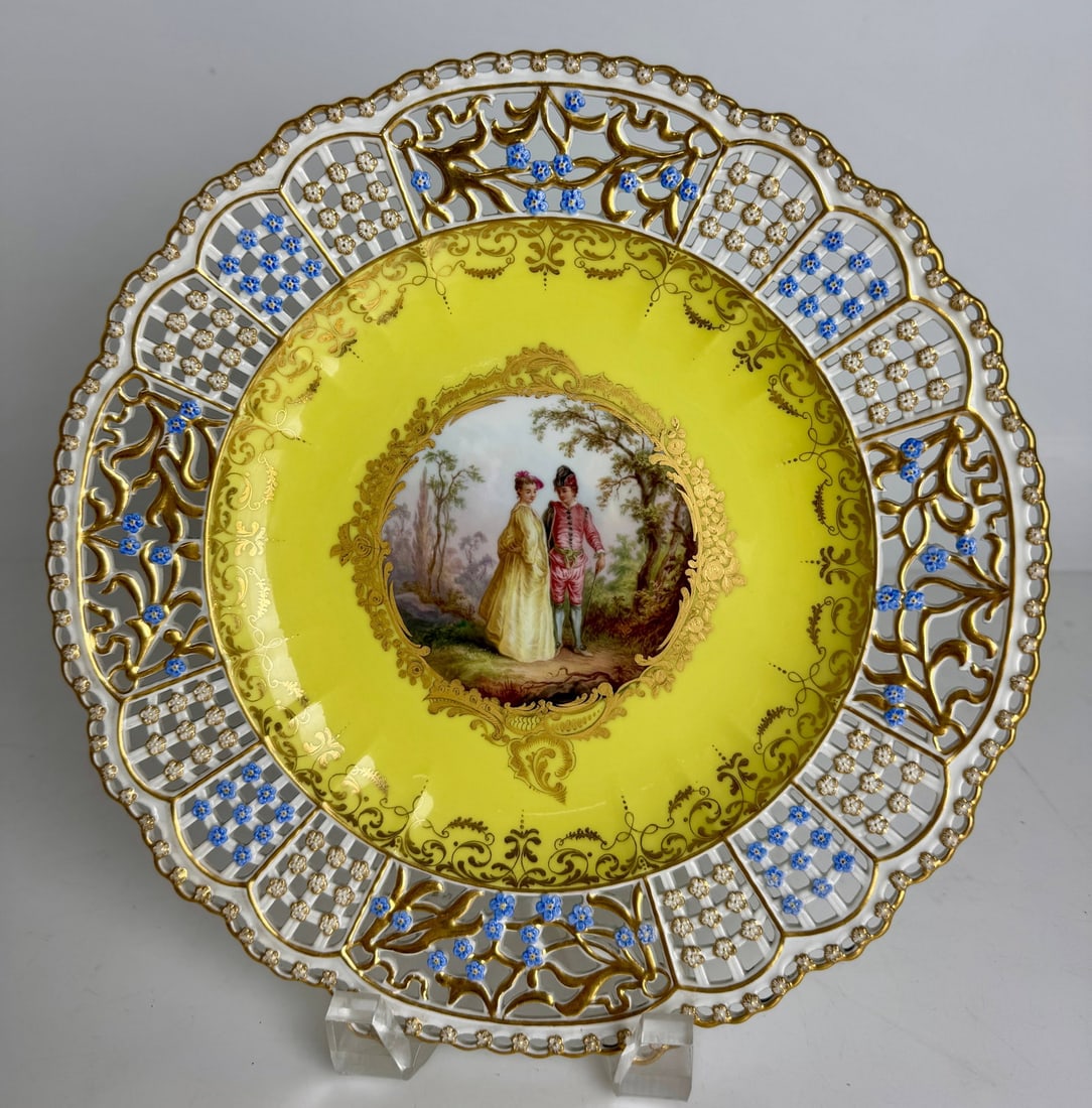 19TH C. MEISSEN YELLOW GROUND RETICULATED PLATE: Painted with Watteau scene . Measures 11” d. In mint condition. Estimate $2500-3000