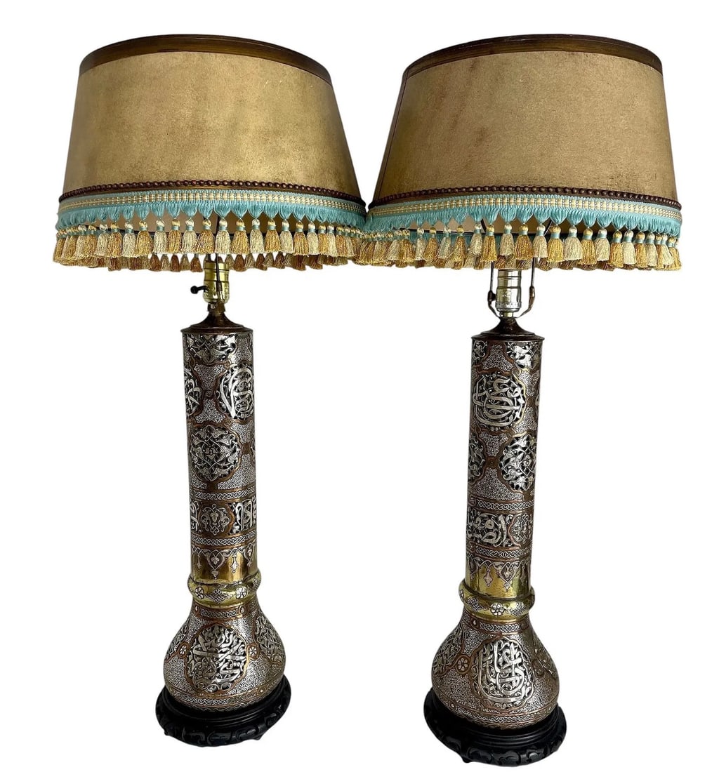 A VERY LARGE PAIR OF ISLAMIC SILVER INLAID LAMPS: Circa 1900. Measure 32 inches overall high. Estimate $10.000-12.000