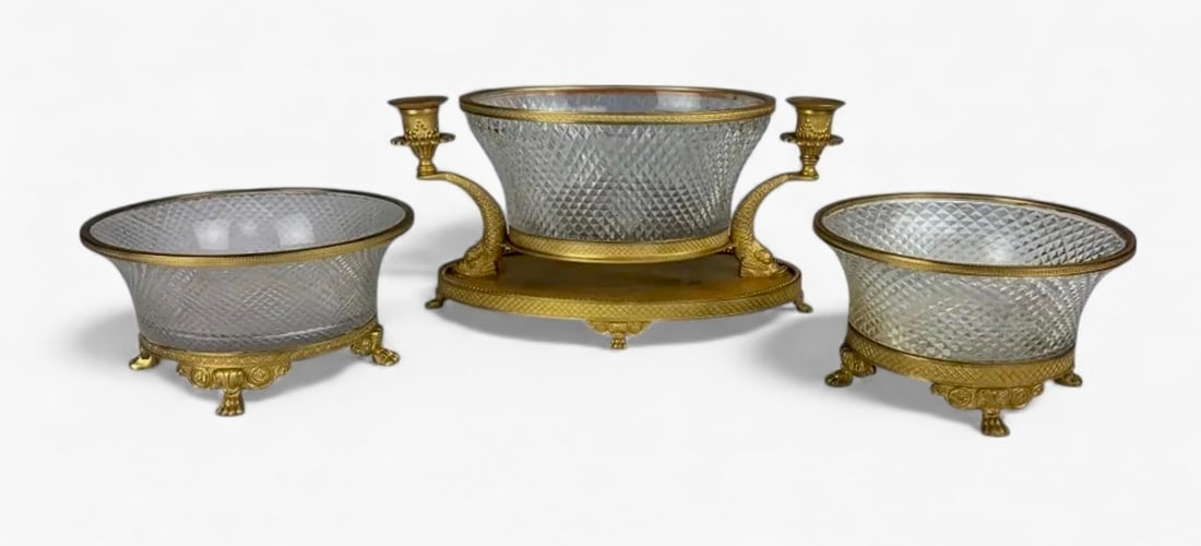 3 PIECE EMPIRE STYLE DORE BRONZE AND BACCARAT CRYSTAL GARNITURE: Circa 1900. Largest piece 12 inches long. In good antique condition. Estimate $2.000-2.500
