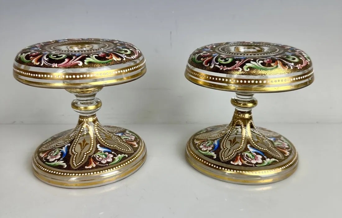 A PAIR OF ENAMELED AND GILT MOSER CANDEL HOLDERS: Circa 1900. Measure 5.5 inches h. In good condition. Estimate $800-1.000