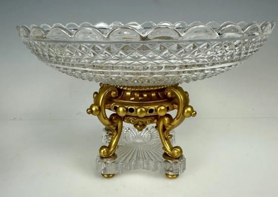 A SIGNED ORMOLU MOUNTED BACCARAT CRYSTAL CENTERPIECE: Circa 1900. Measures 9 inches d. , 6 inches h. In good condition. Stamped Baccarat on the bronze .Estimate $1.000-1.200