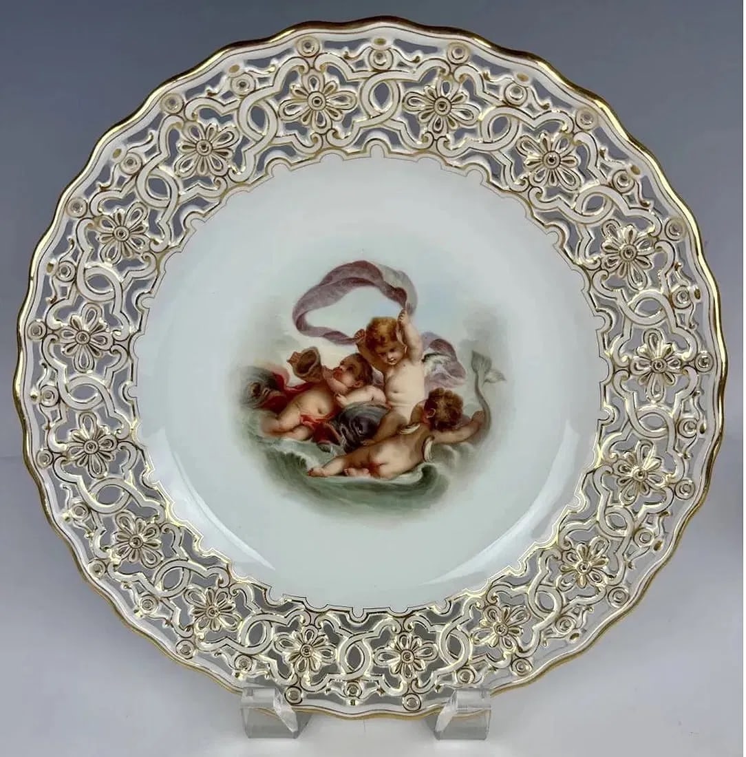 19TH C. RETICULATED MEISSEN PLATE: Painted with Watteau scene. Measures 10 inches d. In excellent condition, minor loss of gold. Estimate $2.500-3.000