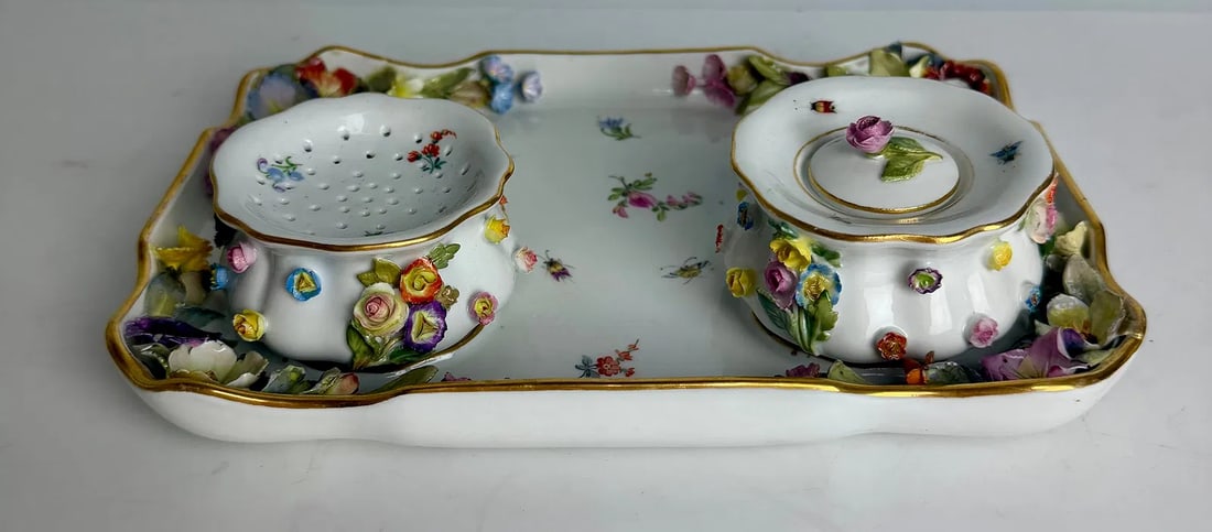 19TH C. FLOWER ENCRUSTED MEISSEN INKWELL: First quality , measures 8 inches long. In overall good condition, minor loss of petals. Estimate $400-500