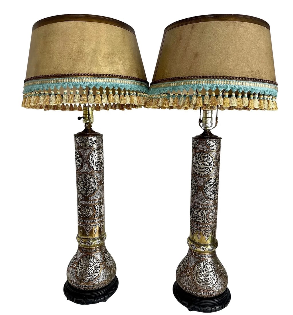 A VERY LARGE PAIR OF ISLAMIC SILVER INLAID LAMPS: Circa 1900. Measure 32 inches overall high. Estimate $10.000-12.000