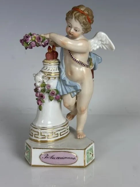 19TH C. MEISSEN MOTO CHERUB: First quality cross swords mark. Measures 5.5 inches high. In overall good antique condition.Estimate $800-1.000