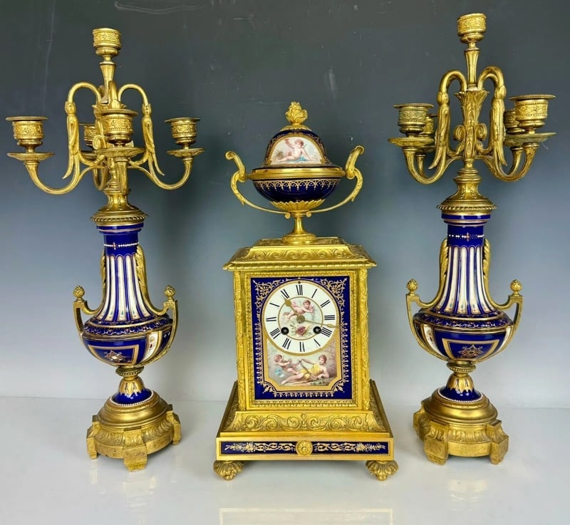 19TH C. DORE BRONZE AND SEVRES PORCELAIN CLOCK SET: Clock measures 17.5 inches high, candelabra measure 20.5 inches high. In very good antique condition, no breaks, no repairs. Estimate $4000-5000