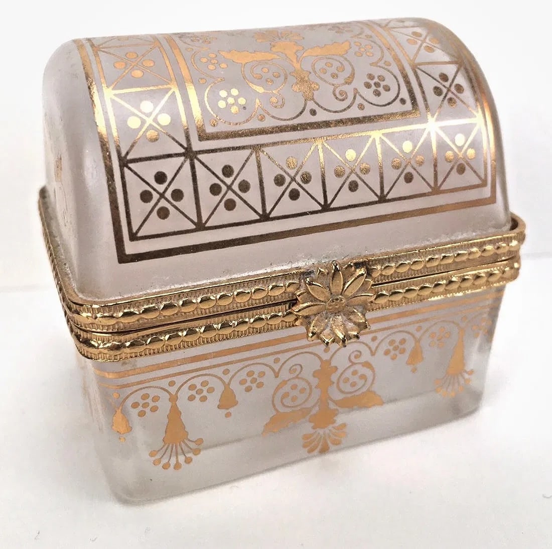 DOMED GILT OPAQUE GLASS BOX ESTE LAUDER: Size: Approx. 2" L x 1.5" W x 1 7/8" H. In excellent condition. Estimate $100-150