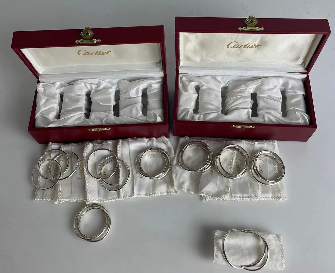 SET OF 8 CARTIER STERLING SILVER NAPKIN RINGS: All marked Sterling ,Cartier. In excellent condition. Estimate $2000-2500