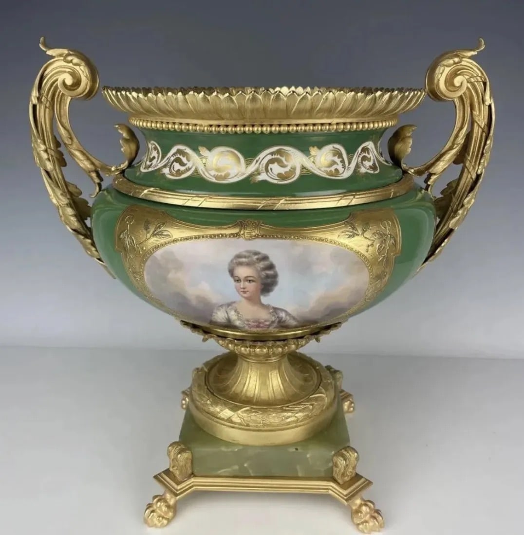 A LARGE ORMOLU MOUNTED SEVRES PORCELAIN CENTREPIECE: Circa 1900. Measures 24 inches Handel to Handel , 18 inches tall. Estimate $2.500-3.000