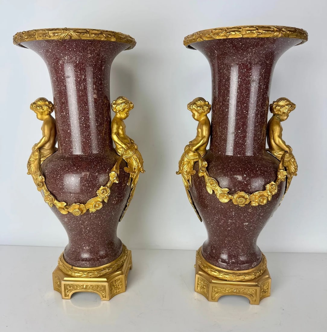 A PAIR OF ORMOLU MOUNTED PORPHYRY VASES: Circa 1900. Measure 18 inches high. In good condition. Estimate $8000-10000