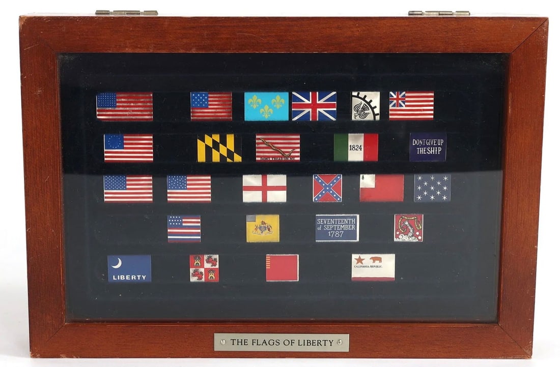 FRANKLIN MINT STERLING SILVER ENAMEL INGOTS FLAGS OF LIBERTY: 1987 Franklin Mint "Flags of Liberty" stamped sterling silver ingots, 25 pieces total. Includes wood display case. Size: 10.25 x 7 x 1.75 Estimate $400-500