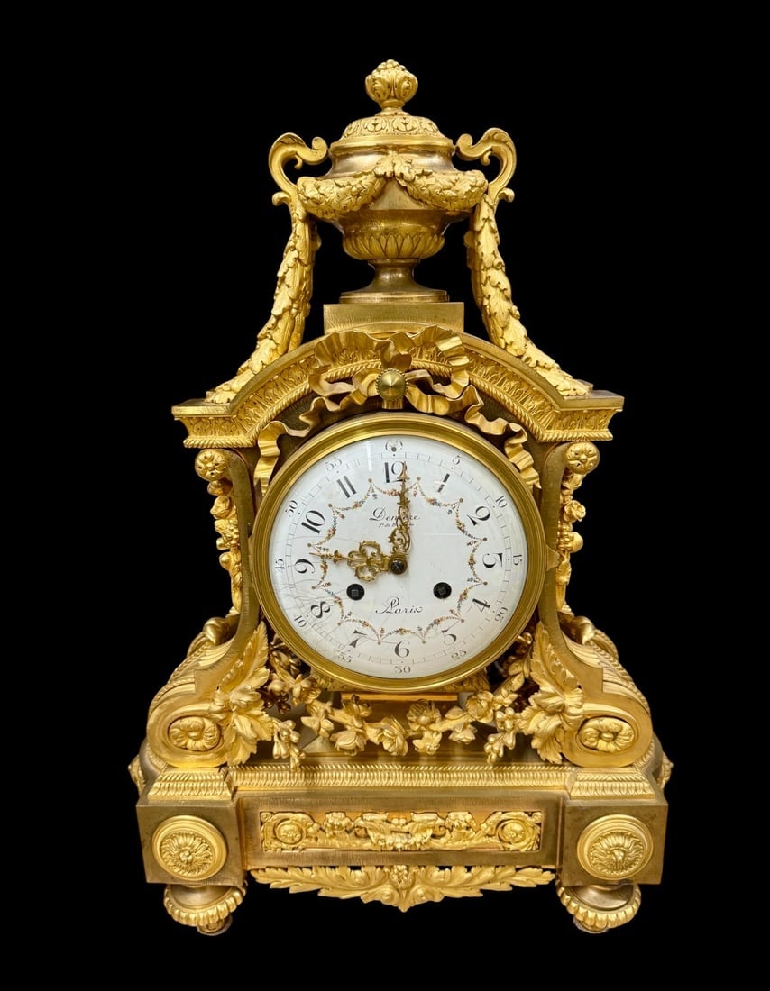 A FINE DENIER ORMOLU CLOCK: Circa 1900. Signed Denier Paris. Measures 23.5” h. Face cracked. Estimate $3000-5009