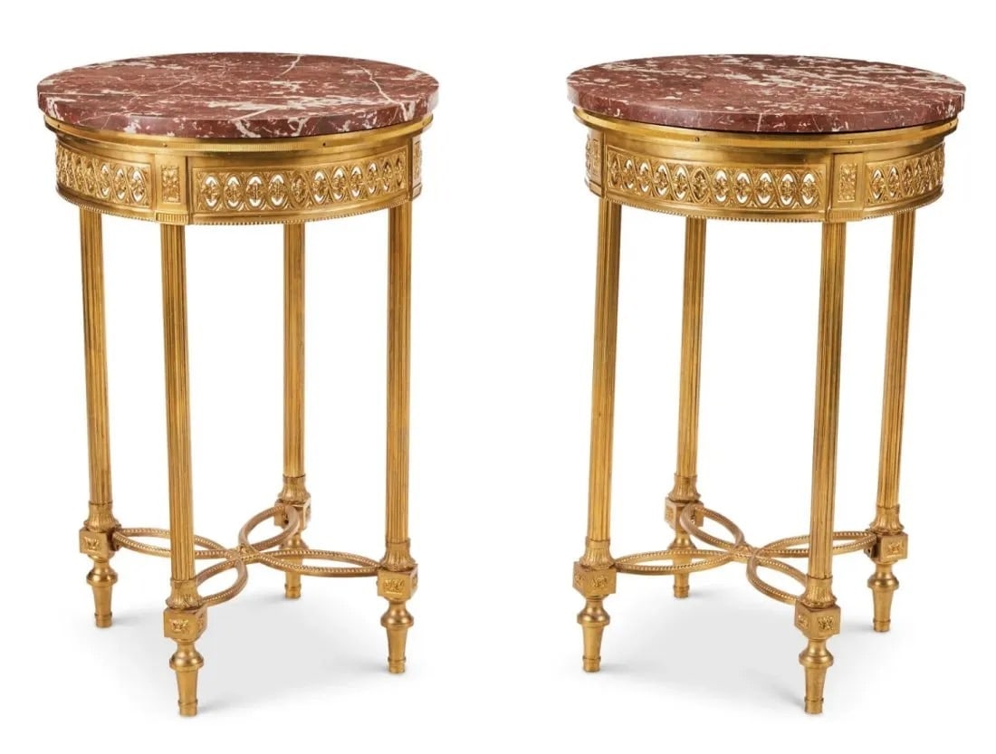 A PAIR OF MARBLE TOP ORMOLU SIDE TABLES: Circa 1900. A Pair of Ormolu tables with pierced floral motif apron and four columnar legs with tapered feet joined by a curvilinear X-stretcher, surmounted by a red marble top.Each: 28.5" H x 18.75"