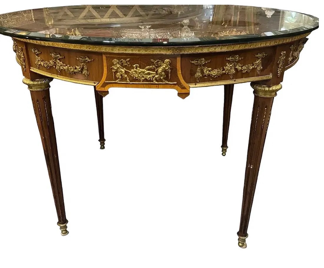 LOUIS XVI STYLE ORMOLU MOUNTED MARQUETRY TOP TABLE: Circa 1900.. measures 38 inches d. Top, and 28 inches high. Small damage to one piece , and top needs to be glued. Estimate $1500-2000
