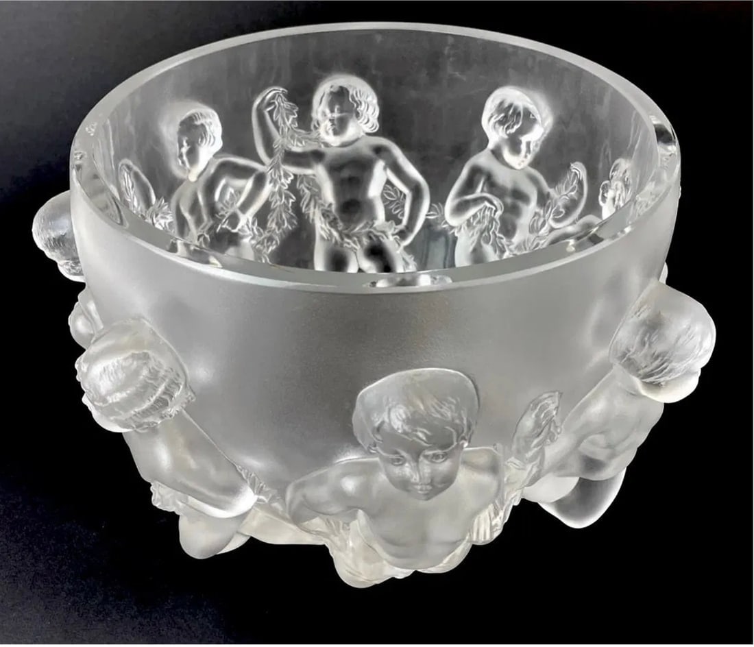 A LARGE LALIQUE LUXEMBOURG CRYSTAL BOWL: With faint engraved signature: Lalique (R) France The frosted lead glass bowl encircled by dancing putti or cherubs with garlands 8.25" H x 12.5" Dia. Good used condition. Estimate $3.000-4.000