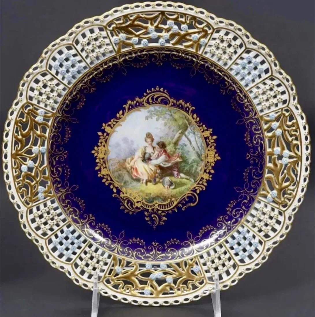 19TH C. RETICULATED MEISSEN PLATE: Painted with Watteau scene . Measures 9.5 inches d. Excellent antique condition. Estimate $2.000-2.500