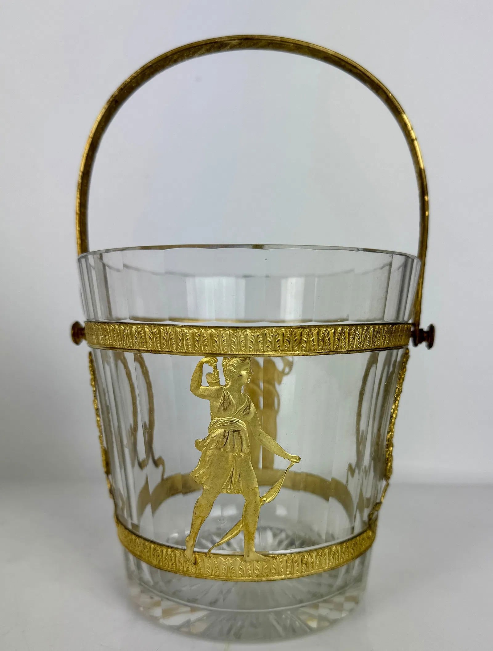 EMPIRE STYLE ORMOLU MOUNTED BACCARAT CRYSTAL ICE BUCKET: Circa 1880. Measures 5.5 inches d., 5.5 inches tall. In good condition. Estimate $1000-1200