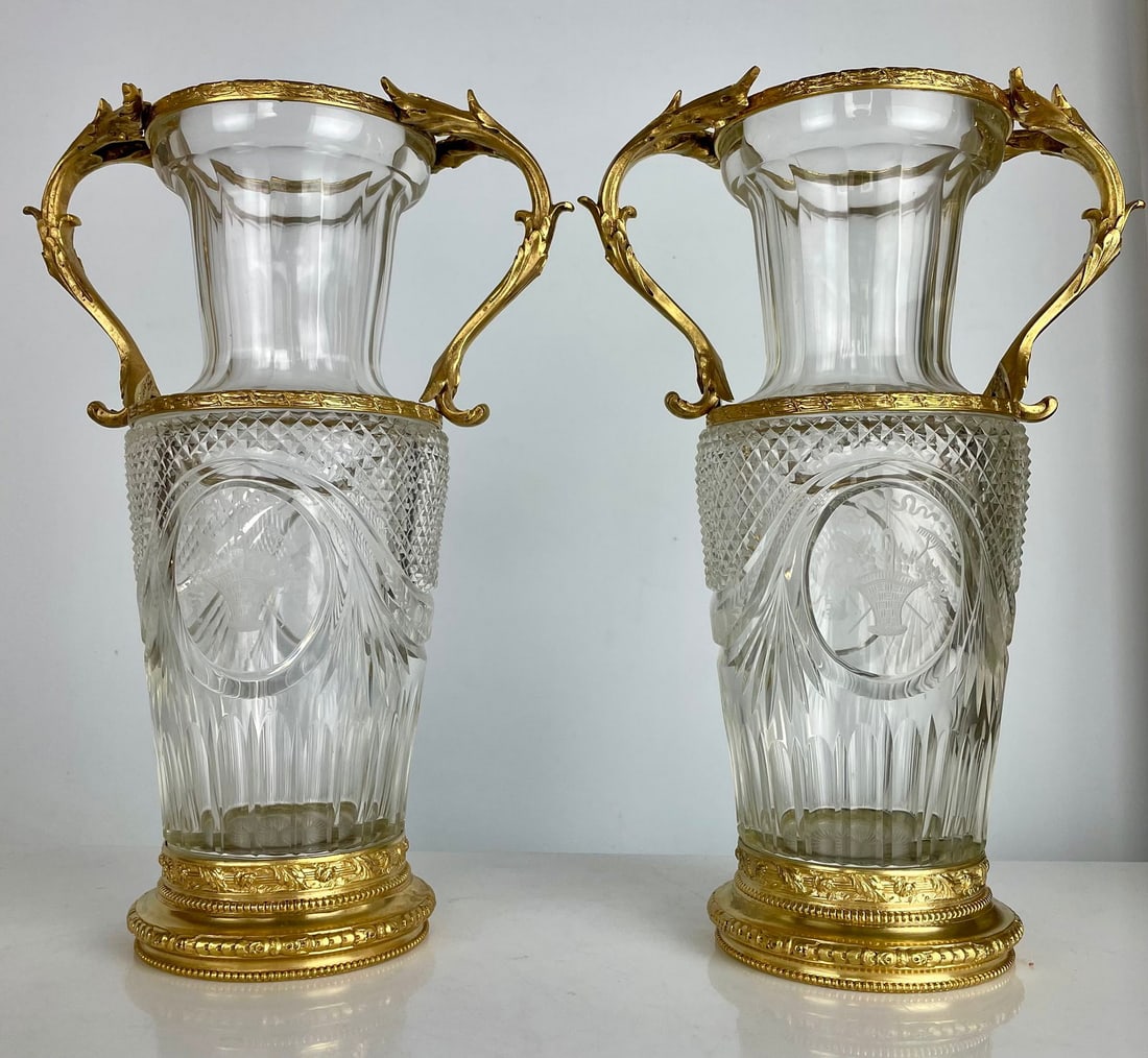 A LARGE PAIR OF ORMOLU MOUNTED BACCARAT CRYSTAL VASES: Circa 1900. Measure 12.5 inches high. In excellent condition. Estimate $2000-2500
