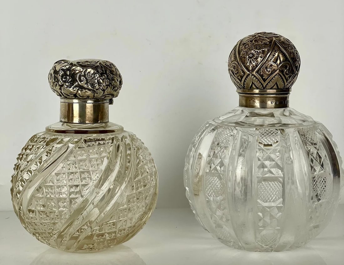 2ENGLISH CUT CRYSTAL AND SILVER PERFUME BOTTLES: Tallest 6.5 inches . Silver hall marks, in good condition. Estimate $400-500