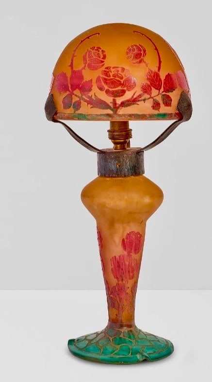 DAUM NANCY LAMP: Circa 1900. wheel-carved cameo glass, wrought iron, etched 'Daum Nancy' with Cross of Lorraineheight 14in (36cm); diameter of shade 5 1/2in (14cm)Excellent condition. Estimate $5000-6000