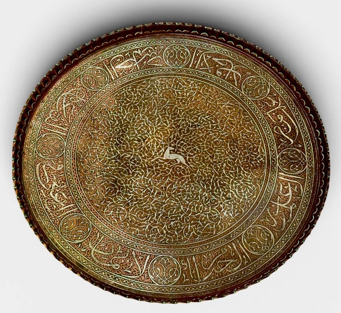 A VERY LARGE 19TH C. ROUND ISLAMIC SILVER INLAID PLATTER: Measures 26” d. In very good condition. Estimate $4000-5000