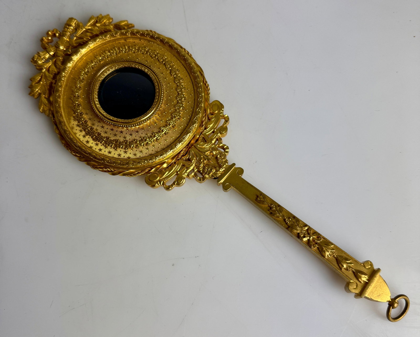 ORMOLU MIRROR: Circa 1900. Measures 10”. In excellent condition. Estimate $400-500