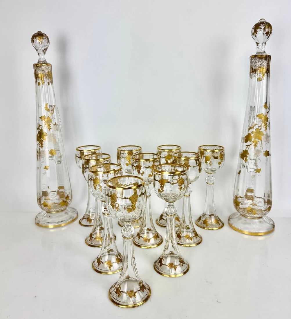 A FINE SET OF MOSER ENAMELED MOSER LIQUOR SET: Circa 1900. Comprising of 2 large liquor bottles, and 10 wine glasses. Bottles 18 inches , glasses 8 inches h.All in excellent condition. Estimate $1500-2000