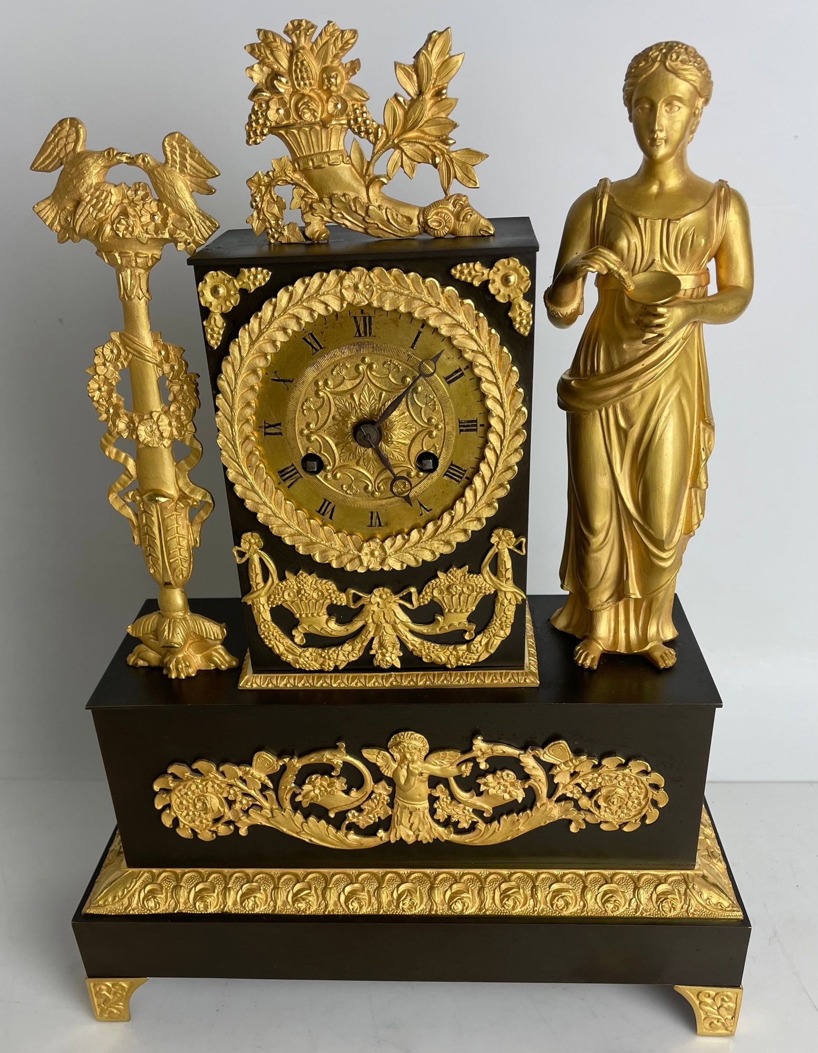 EMPIRE ORMOLU CLOCK: Circa 1820. Measures 14” high. Estimate $1500-2000