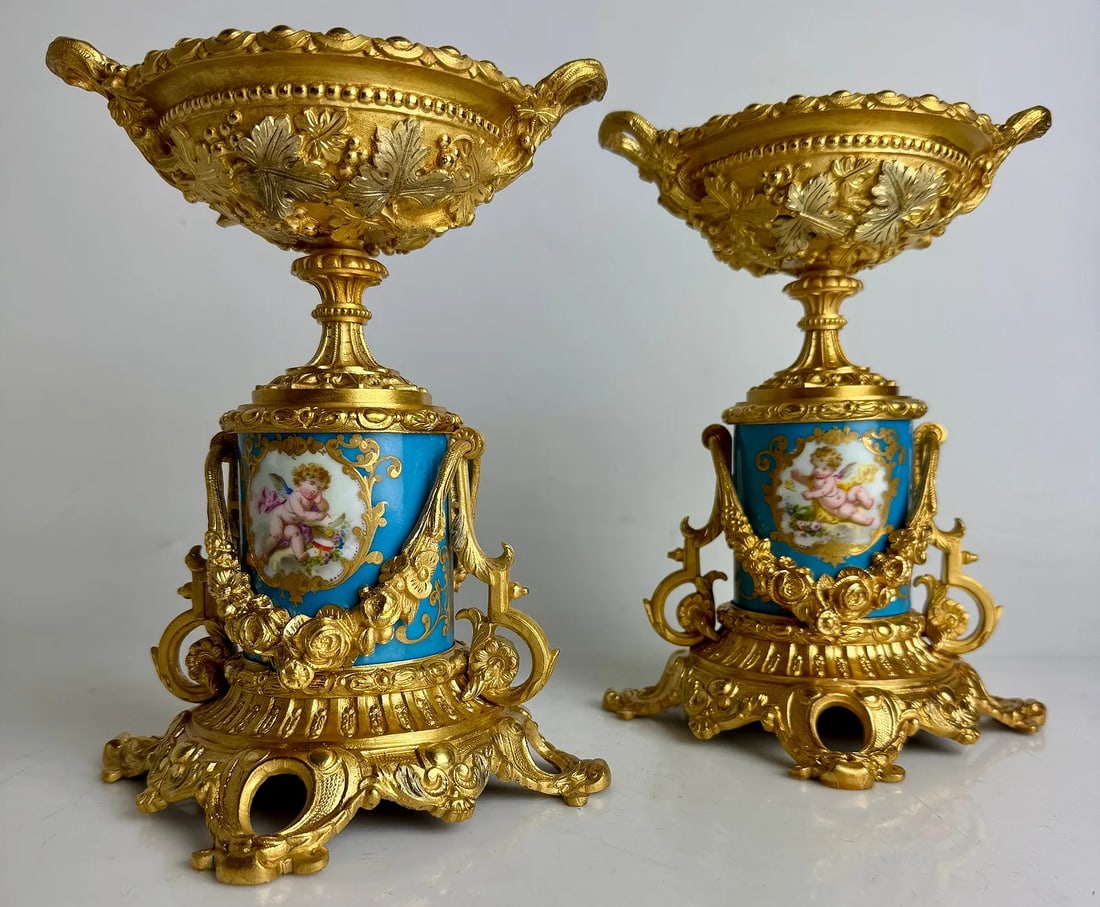 A PAIR OF ORMOLU MOUNTED SEVRES VASES: Circa 1900. Measure 8.5” h. In excellent condition. Estimate $1200-1500
