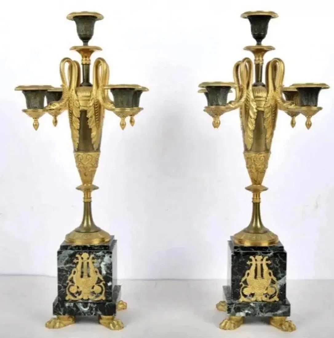EMPIRE STYLE BRONZE AND MARBLE CLOCK SET: Circa 1900. Clock measures 22 inches long, 18.5 inches high. Candelabra 20 inches high. Estimate $8.000-10.000