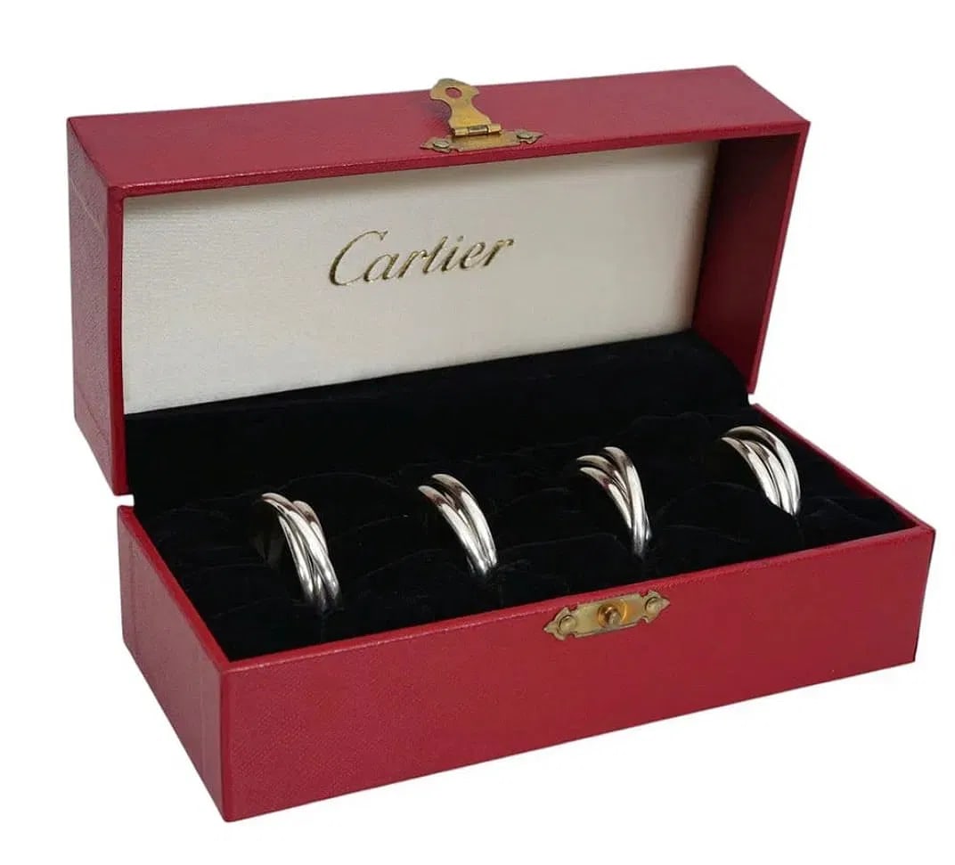SET OF 4 STERLING SILVER CARTIER NAPKIN HOLDERS: All signed. In original box. Estimate $1000-1500
