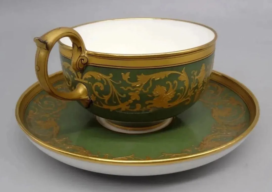 19TH C. SEVRES CUP AND SAUCER: very high quality Sevres porcelain cup and saucer, highly gilded on green ground.This has lozenge Sevres mark to the base with the number 80 for 1880 and is also inscribed - please see final photo.In 
