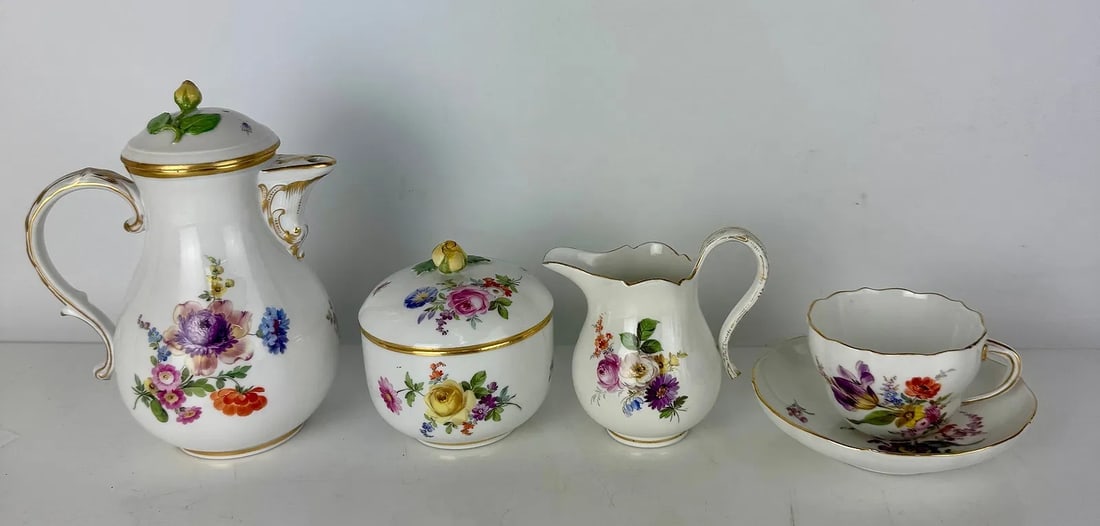 19TH C. MEISSEN TEA SET: Comprising of teapot, sugar, milk, and one cup and saucer. Minor restoration to milk jug.Estimate $600-800