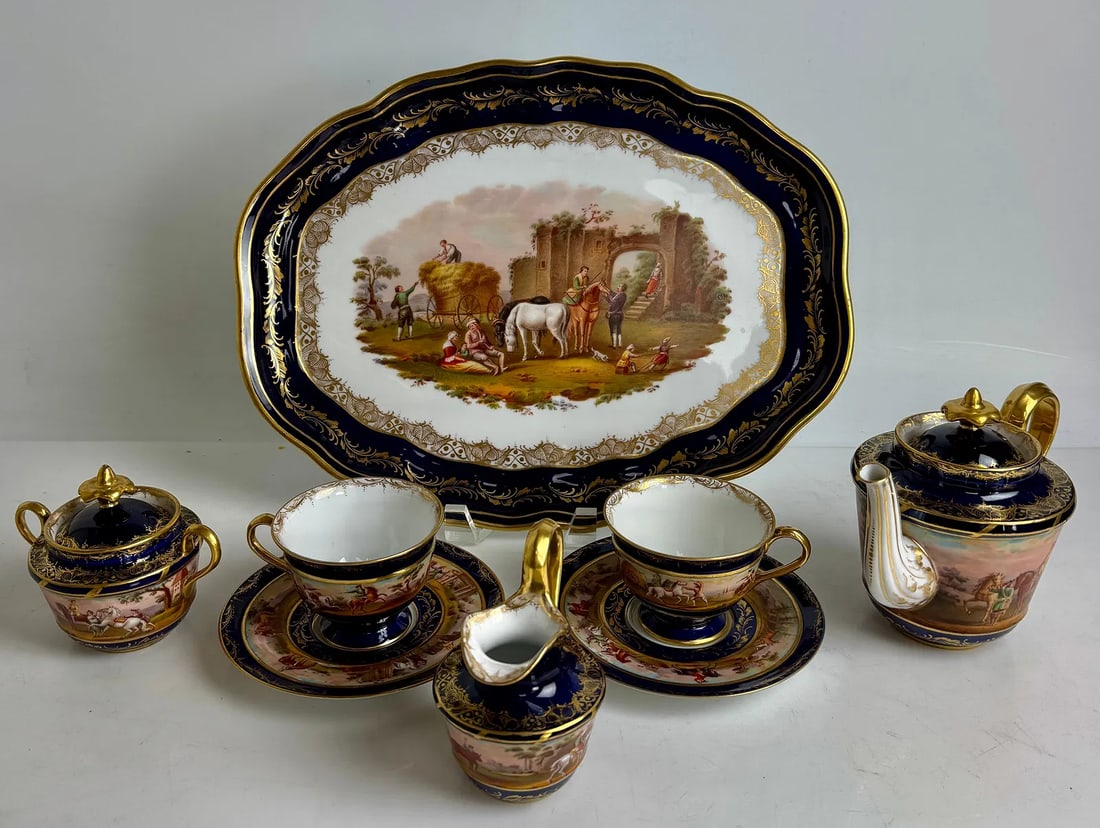 ROYAL VIENNA TETE-A-TETE: Circa 1900. Consisting of a tray measuring 14 inches x11 inches , 2 cups and saucers , tea pot, sugar pot, and milk jug. All in perfect condition. Estimate $3500-4000