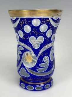 A MAGNIFICENT GILT AND ENAMELLED MOSER BEAKER: Circa 1900. Measures 5.5 inches high. In good antique condition. Minor loss of gold. Estimate $1.500-2.000