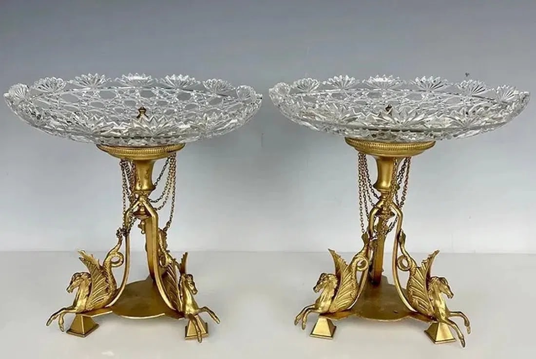 A PAIR OF ORMOLU AND BACCARAT CRYSTAL TAZZAS: Circa 1900. Measure 9 inches high, 9 inches diameter of top. In good antique condition.Estimate $1.500-2.000