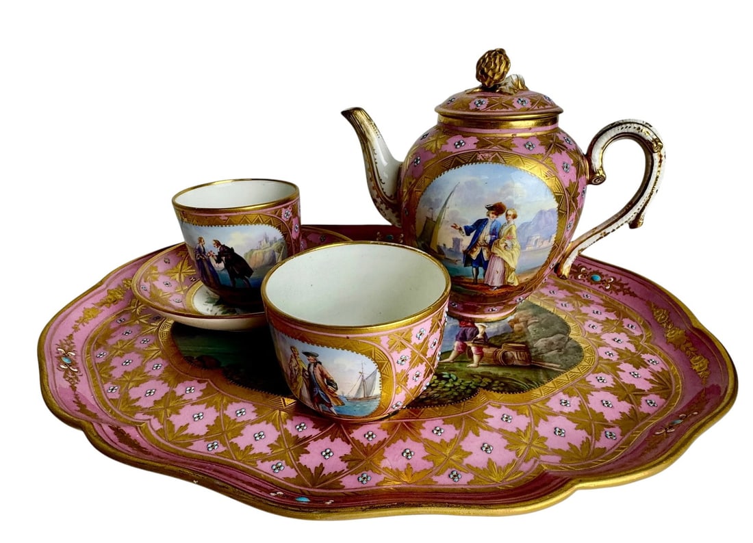 A JEWELLED SEVRES PETIT DE JOURNE SET: Comprising of a tray, tea pot, sugar pot and a cup and saucer. Tray 13.5”x10.5”, In mint condition, small restoration to spout of teapot. Estimate $4000-5000