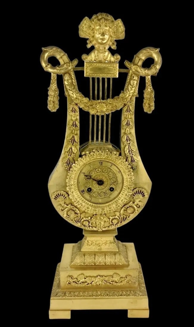 EMPIRE STYLE DORE BRONZE CLOCK: Circa 1880. Measures 21 inches tall. Estimate $2.000-2.500