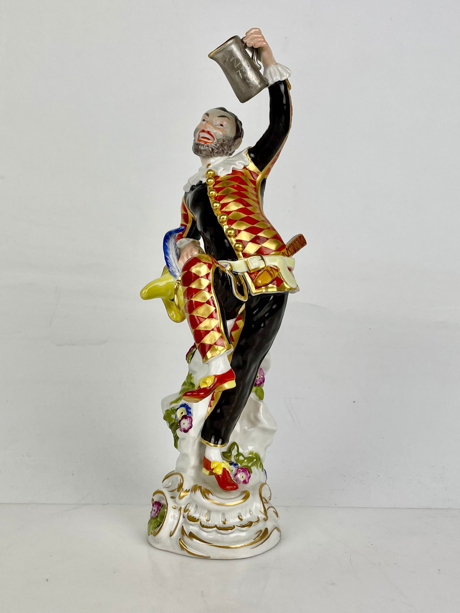 ANTIQUE MEISSEN FIGURE HARLEQUIN: Meissen Figure Harlequin With aJug Mnr: 64551, circa 1950, measures 9.5 inches tall. In very good condition. Estimate $1500-2000