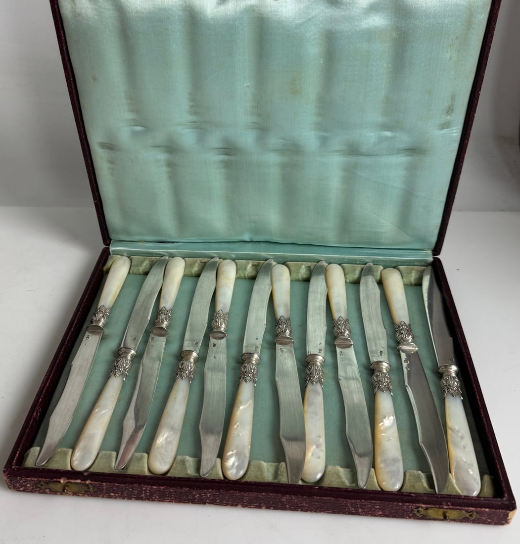 SET OF 12 CONTINENTAL SILVER AND MOTHER OF PEARL KNIVES: Circa 1900. Estimate $600-800
