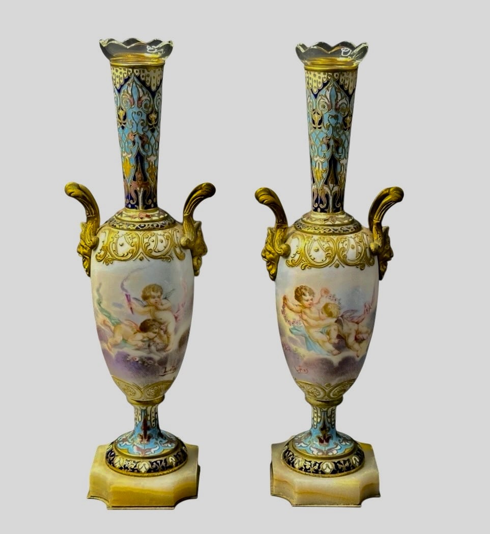A PAIR OF FRENCH SEVRES AND CHAMPLEVE ENAMEL VASES: Circa 1900. Measure 10.5” high. In good condition. Estimate $800-1000
