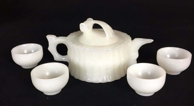CHINESE WHITE JADE TEA SET: Tea pot and 4 cups .teapot measures 8"w., 5.5" H. Cups measure 2" D. Excellent condition. Estimate $400-500