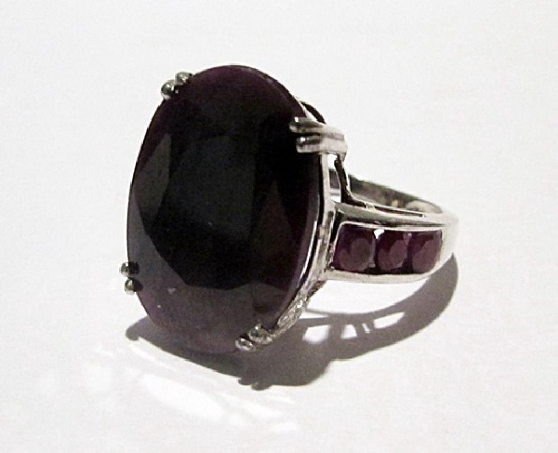 10K Yellow Gold Ruby Ring: This 10k yellow gold ruby ring is comprised of 4 prongs set oval cut ruby surrounded by channel set 6 round rubies. This estimated weight of the rubies are 4.85ctw. This estimated weight of the ring i