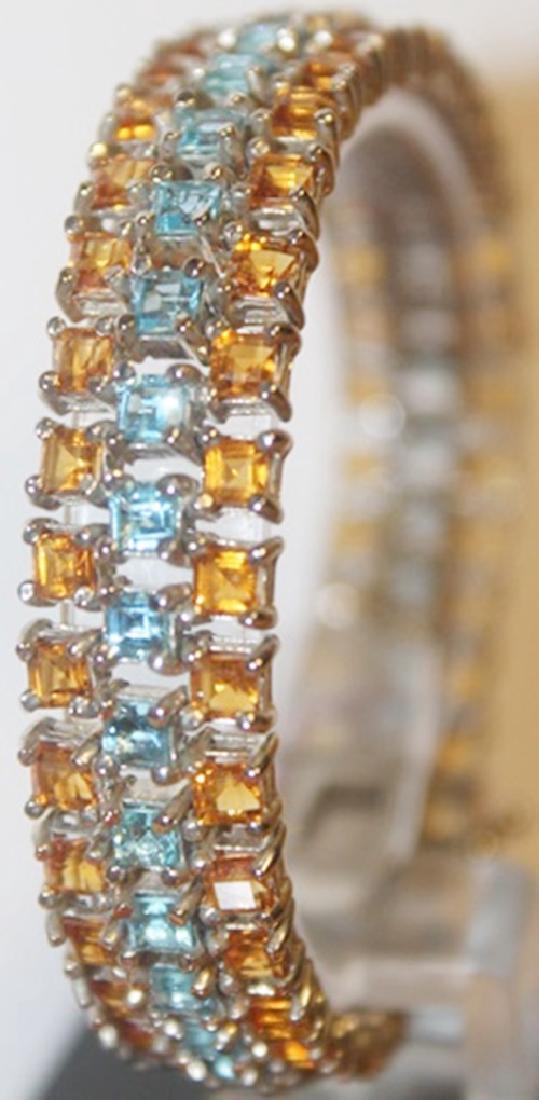 Fancy Blue Topaz and Sapphire Bracelet: Blue topaz and gold sapphire bracelet, 60 ct. Silver.