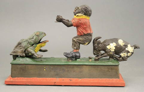 Initiating Bank 1st Degree: Mechanical Novelty Works New Britain, Connecticut - Circa 1895 Place a coin in the boy’s hands. Depress the lever, the goat butts the boy forward and the coin is thrown into the frog. Material: Cast