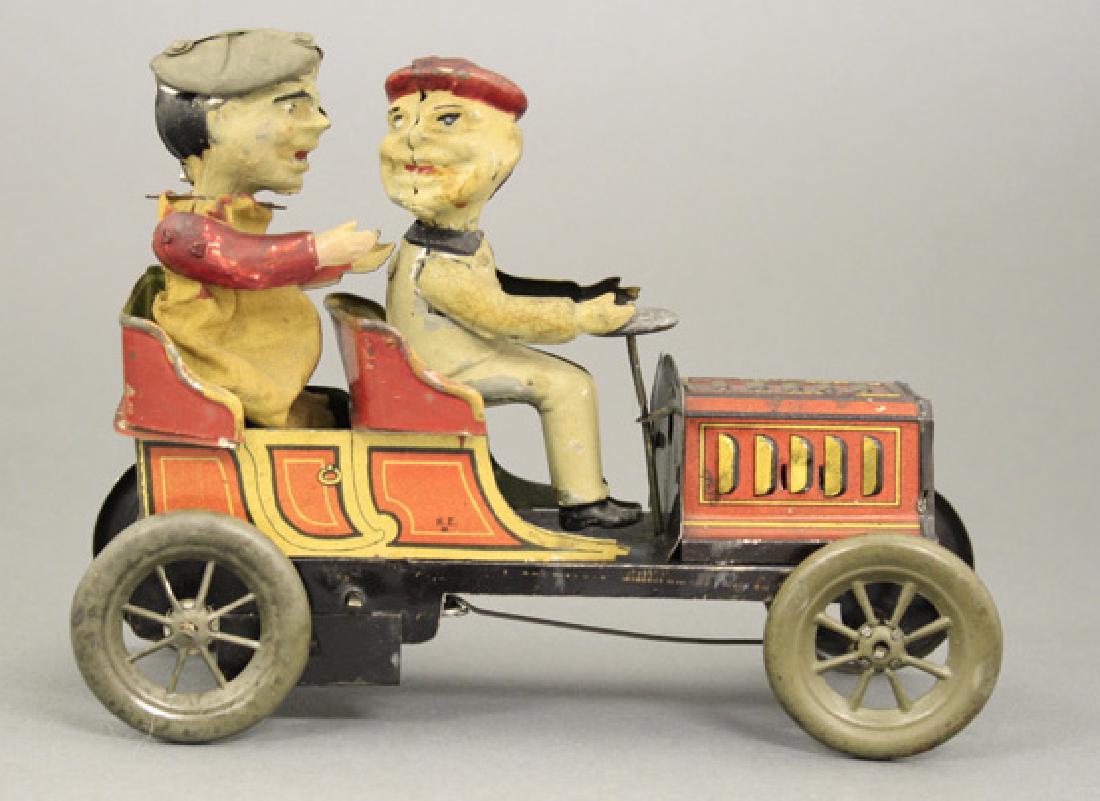 Comic Character Two Seat Touring Car: Marked H. E. N. for Hans Eberl German - Circa 1915 - 7” L This is a scarce early toy auto by Eberl. It is lithographed with hand painted figures. The rear figure goes up and down. The toy works well