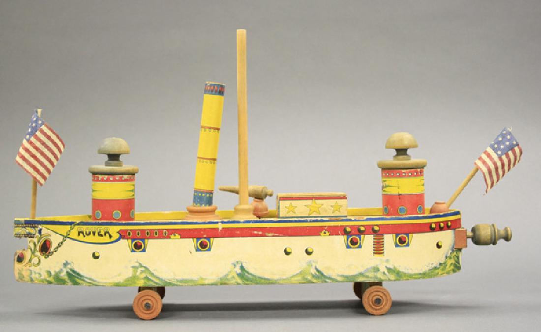 “Rover” Cruiser: Probably Bliss American - Circa 1910 20” W x 11.25” H Complete with working torpedo fired from the front of the boat. Missing one side cannon. Material: Wood and Paper