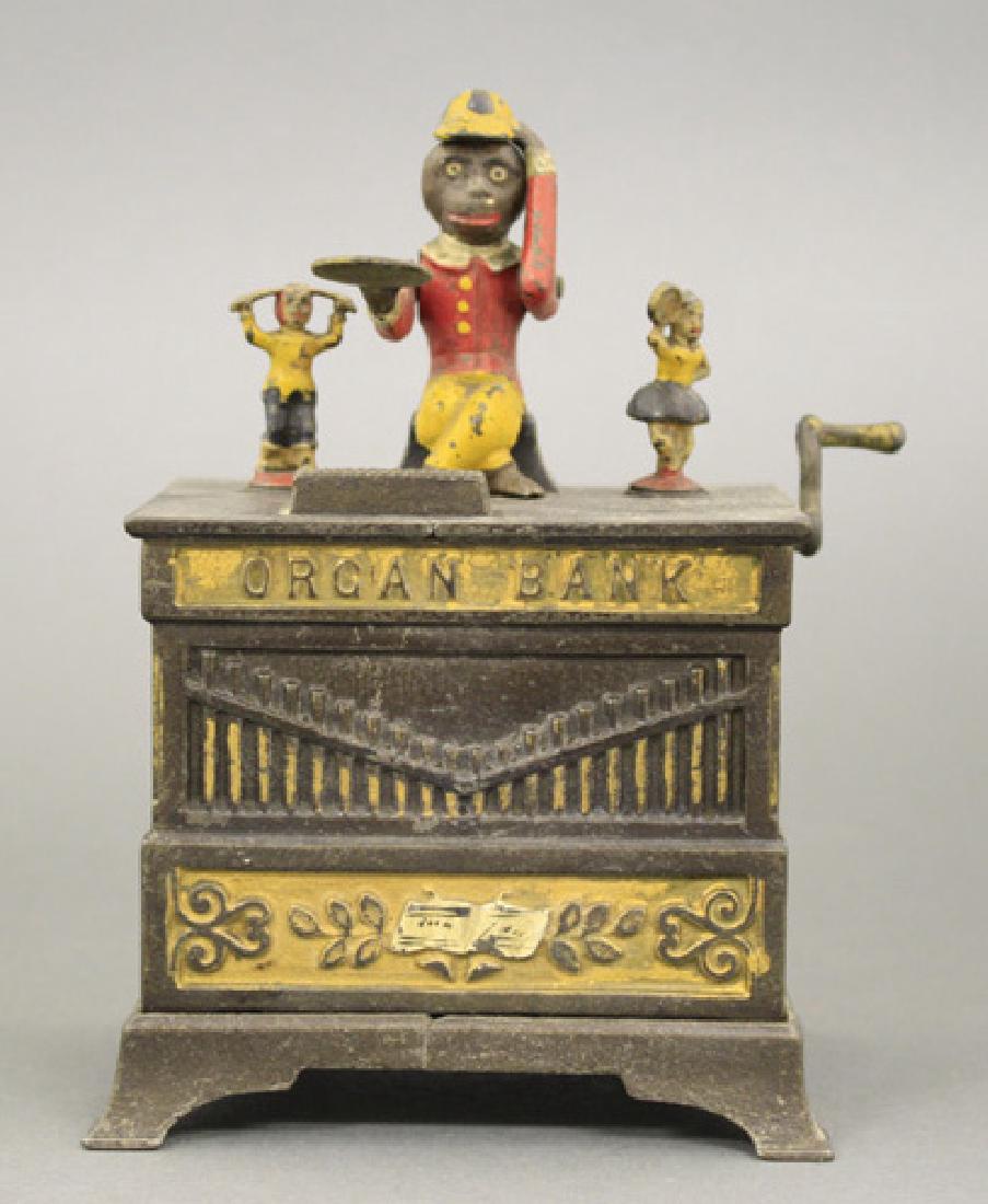Organ Bank - Boy & Girl: Made by the Kyser & Rex Company Philadelphia, Pennsylvania - Circa 1882 The monkey doffs his hat in thanks for the penny you have given him. The children rotate and the bells chime when the crank is t