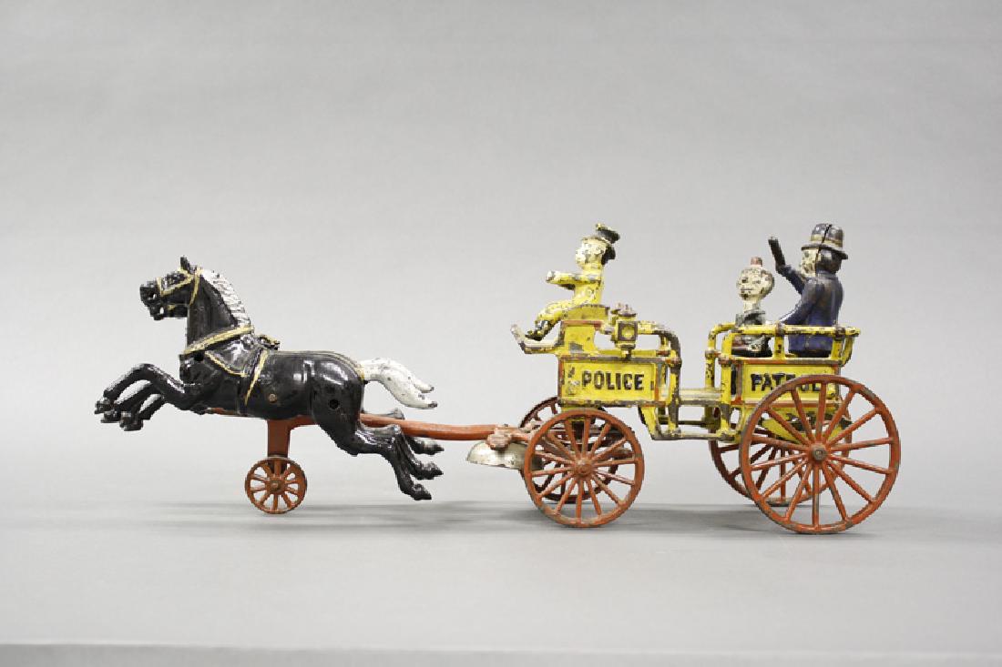 Happy Hooligan Police Patrol: Made by Kenton Hardware. Kenton, Oh. - Circa 1910. 19" Long. This is from a series of comic toys that Kenton produced around 1910. Made of Cast Iron. Very Fine Condition.